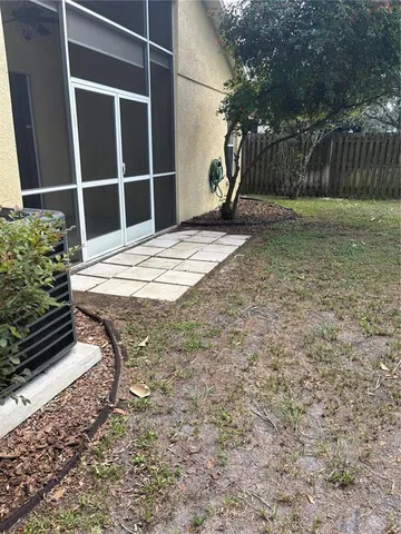 a view of an empty room with wooden fence