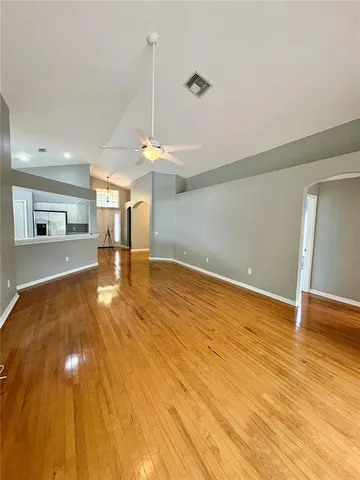 a view of a room with wooden floor