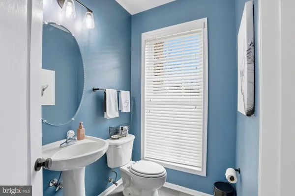 a bathroom with a sink toilet and a mirror