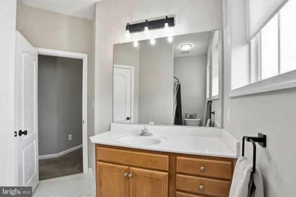 a bathroom with a sink vanity and mirror