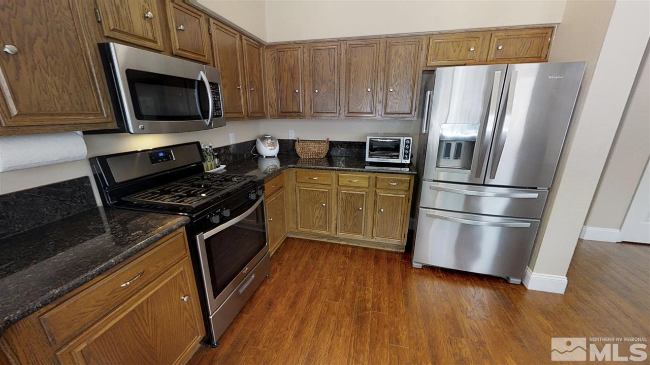 1970 Honey Ridge Drive Reno, NV 89511 - Photo 5 of 25 a kitchen with a refrigerator stove and microwave