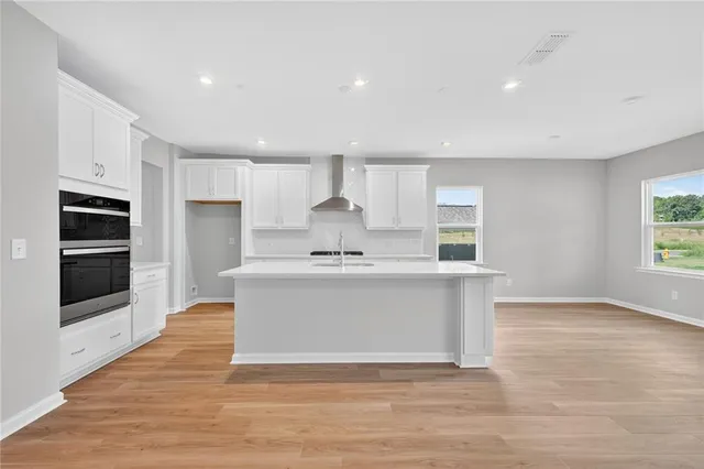 a view of kitchen with stainless steel appliances granite countertop a stove a sink and a refrigerator