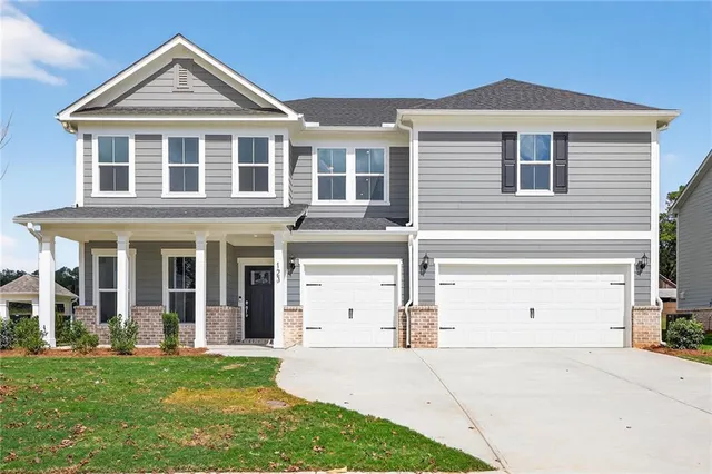 a kitchen with stainless steel appliances kitchen island wooden floors and white cabinets