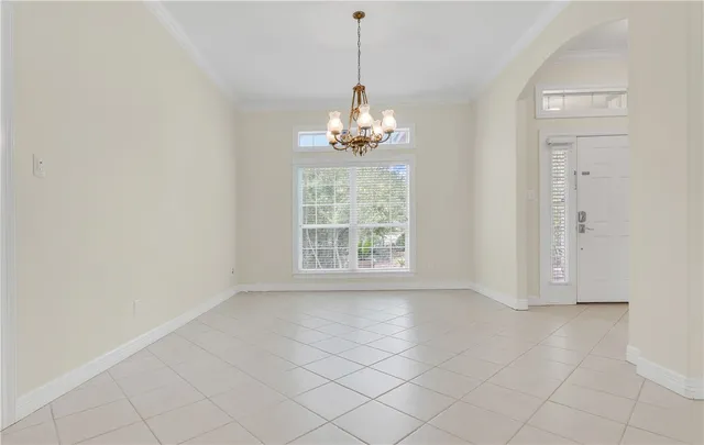 an empty room with windows and entrance