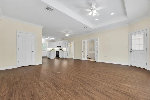 a view of empty room with wooden floor