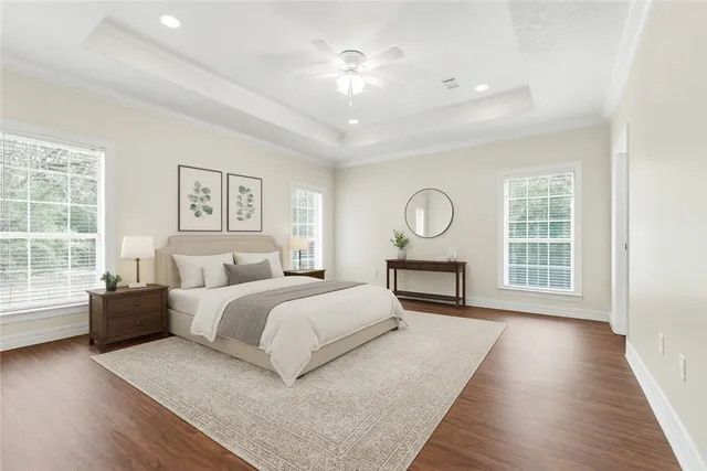 a spacious bedroom with a large bed and a chandelier