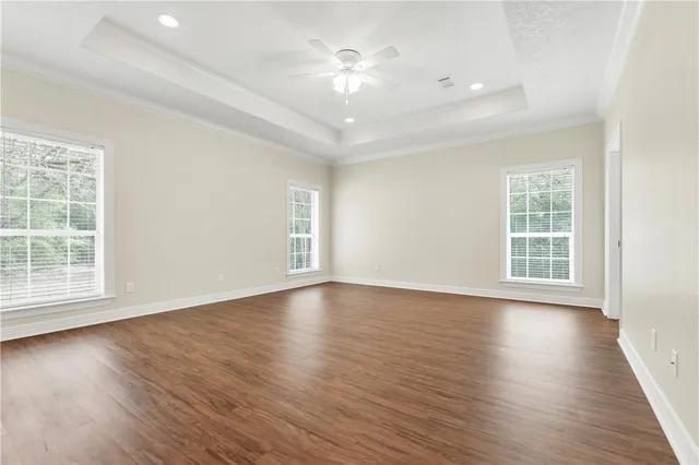 a view of an empty room with wooden floor