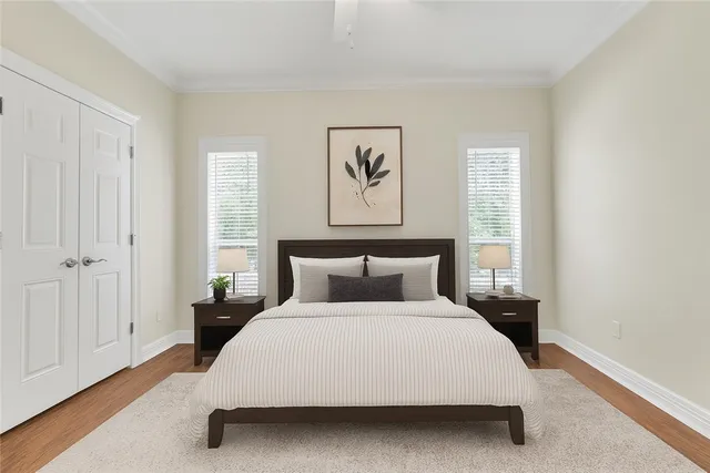 a bedroom with a bed and painting on the wall