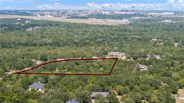 an aerial view of a houses with a yard