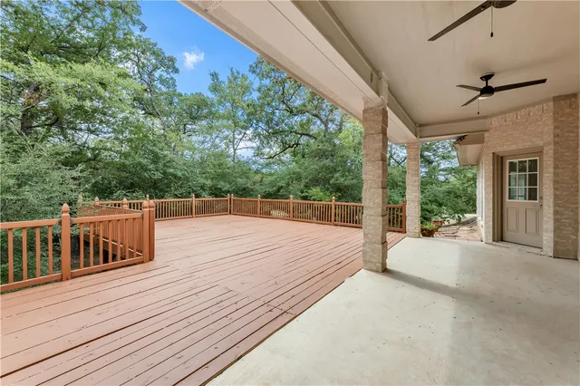 a view of a deck with couches with wooden floor and fence
