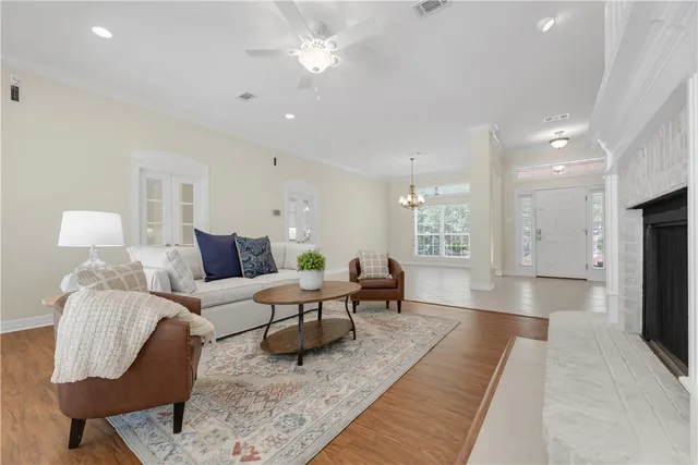 a living room with furniture and a chandelier