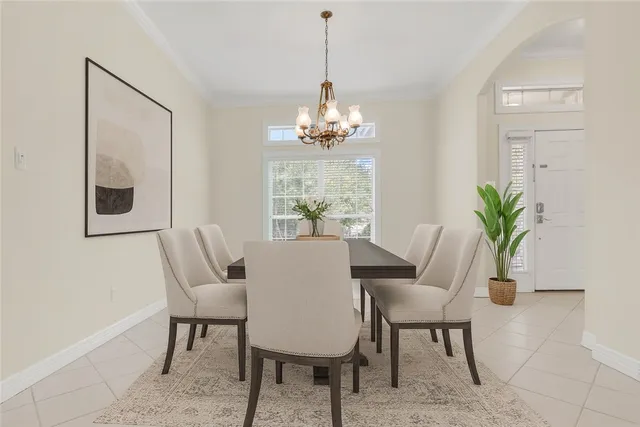 a dining room with furniture potted plants and wooden floor