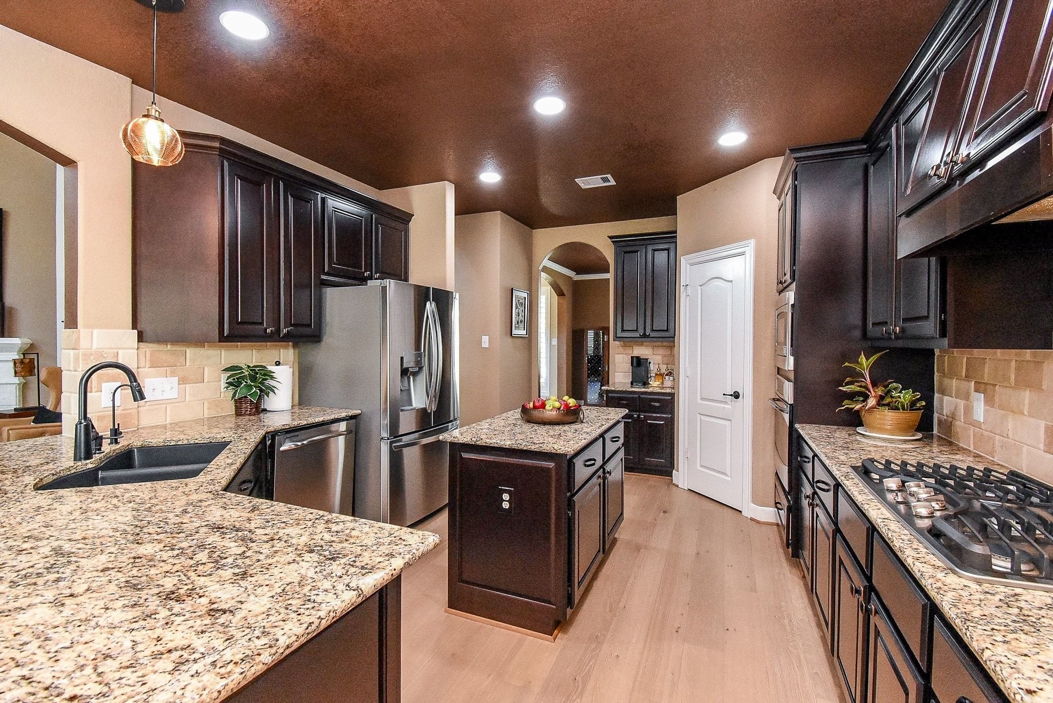 27607 Macklind Ridge Lane Katy, TX 77494 - Photo 24 of 50 Wow, what a functional kitchen. Granite countertops, upgraded undermount sink, kitchen island, reverse osmosis, stainless steel GE Profile appliances, 5 gas burner stove, corner/walkin pantry,