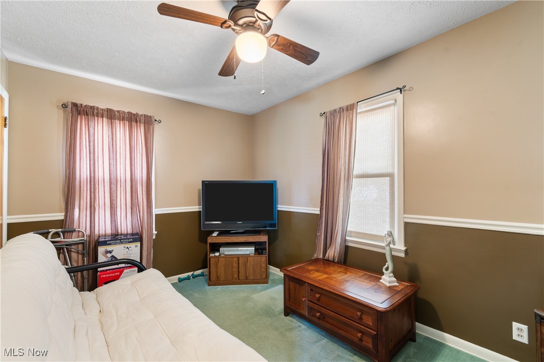 720 Ina Avenue Akron, OH 44306 - Photo 11 of 30 Carpeted living room featuring a textured ceiling and a ceiling fan