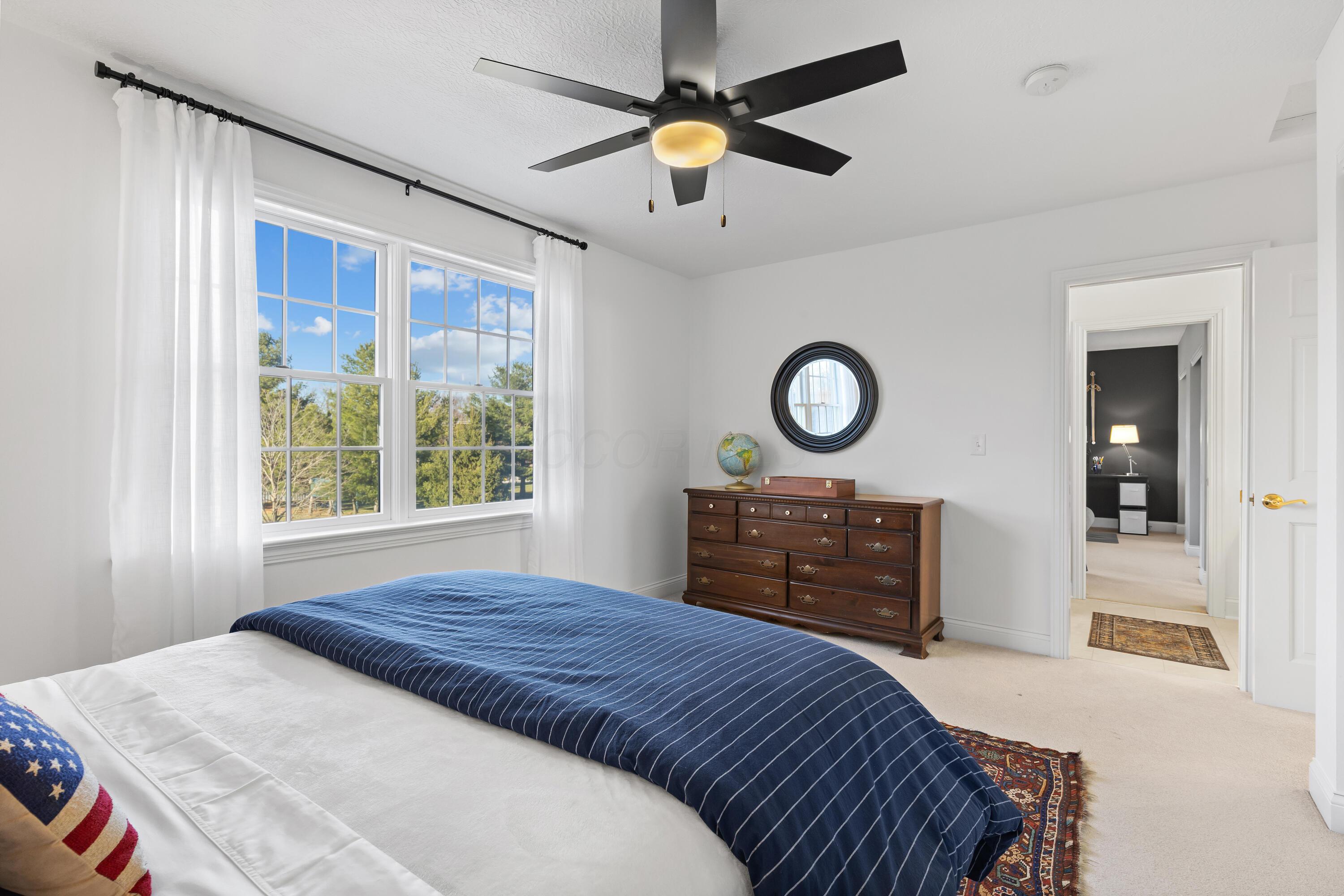 1364 Dale Ford Road Delaware, OH 43015 - Photo 60 of 112 • Light sand carpet • White painted walls • Attic access • Lighted ceiling fan • Closet with double sliding doors • Jack & Jill bath access • Drapes remain