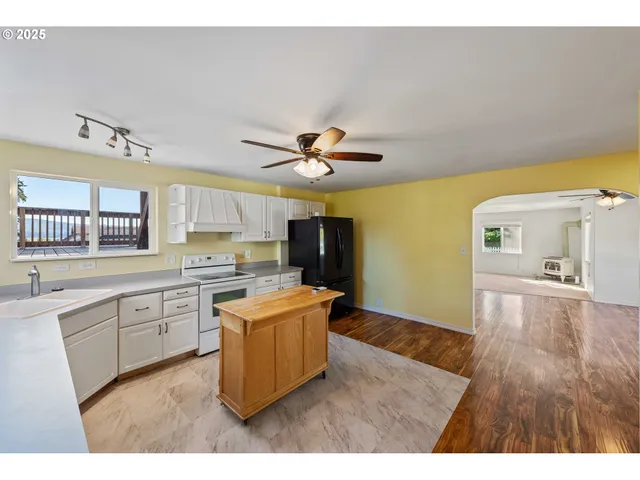 a kitchen with stainless steel appliances a stove cabinets and wooden floor