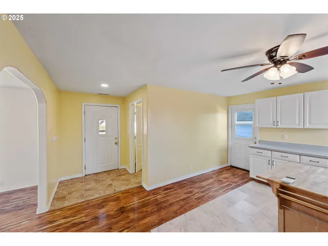 a view of a kitchen with a sink cabinets and wooden floor