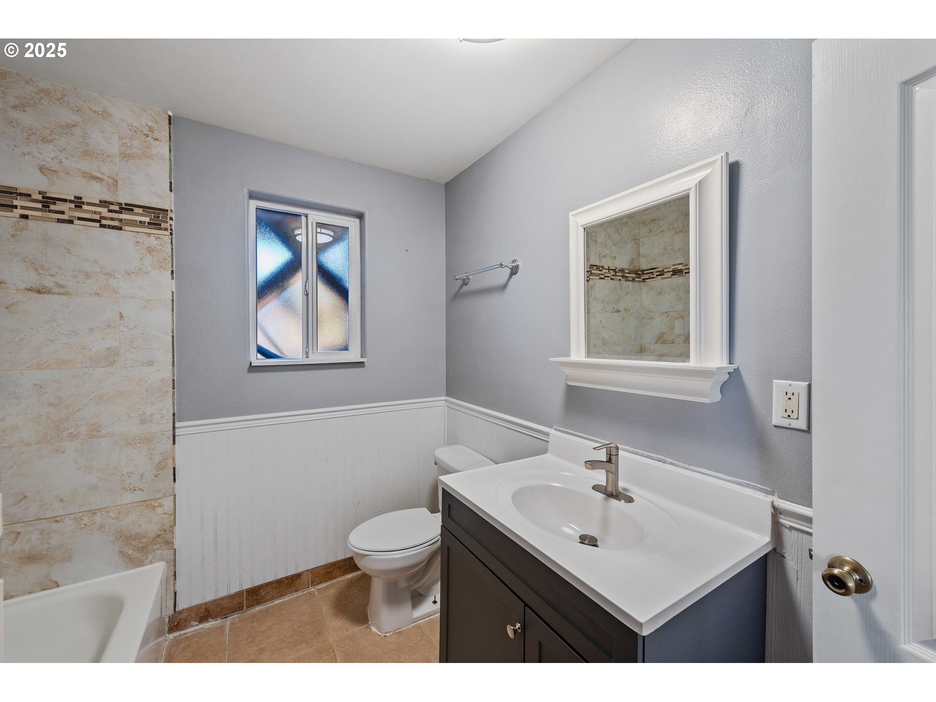 584 Exchange Street North Bend, OR 97459 - Photo 17 of 48 a bathroom with a toilet a sink a mirror and a window