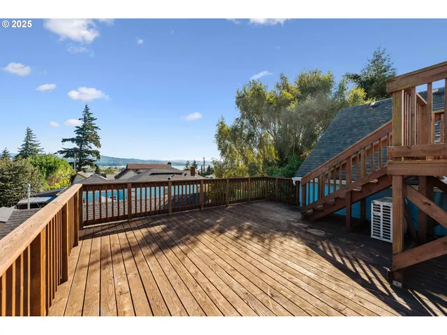 a view of balcony with wooden floor and fence