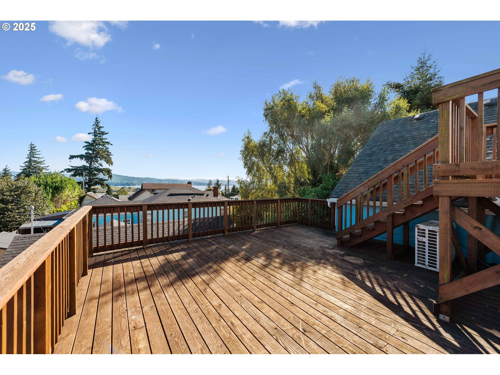 584 Exchange Street North Bend, OR 97459 - Photo 3 of 48 a view of balcony with wooden floor and fence