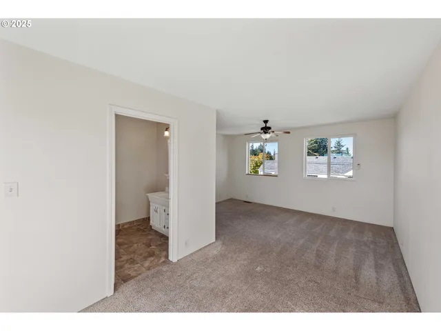 a view of an empty room and a window