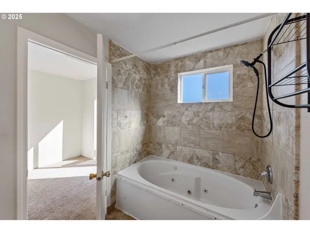 a bathroom with a bath tub and a shower