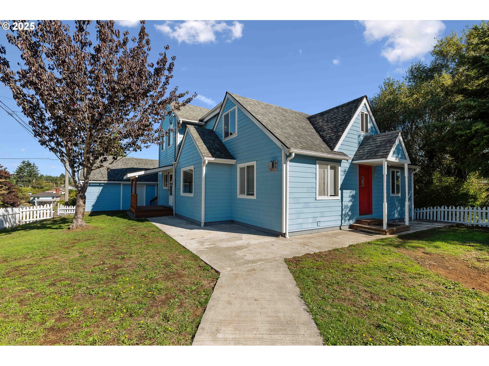 584 Exchange Street North Bend, OR 97459 - Photo 45 of 48 a view of a house with a big yard and large tree