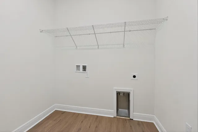 a view of a room with wooden floor