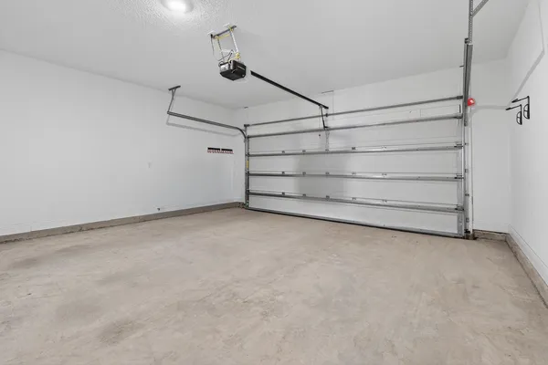 a view of an empty room and a ceiling fan