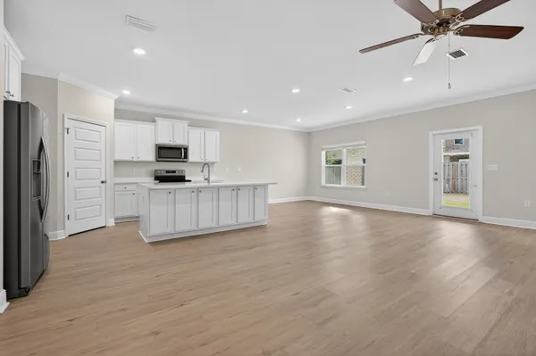 a kitchen with stainless steel appliances a refrigerator sink and microwave