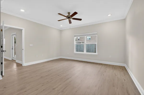 wooden floor in an empty room with a window