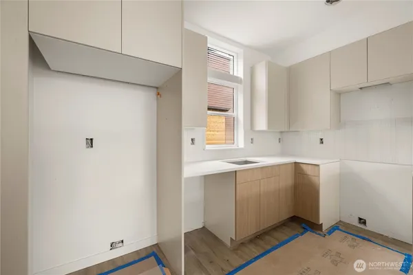 a view of a kitchen with wooden floor