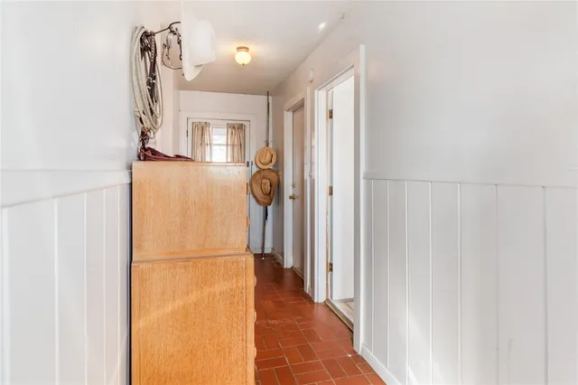 a view of a hallway with a refrigerator and a window