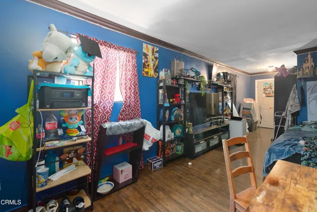 a view of a yard with plants and wooden fence