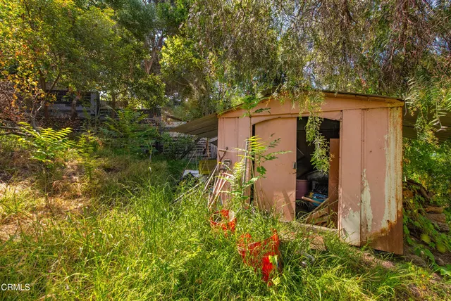a aerial view of a house with a yard and sitting area