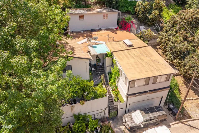 an aerial view of a house with a yard and outdoor seating