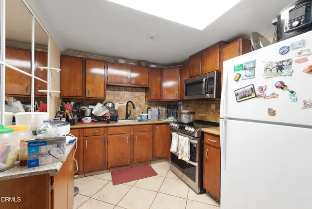 a bed room with a bed a standing desk and a window