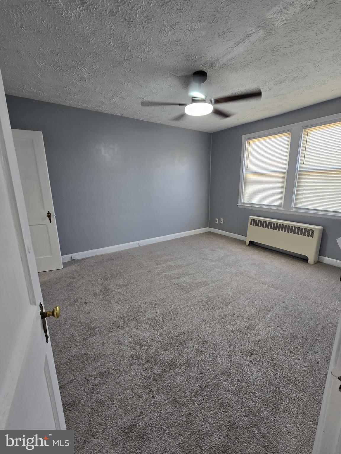6105 Frederick Road Catonsville, MD 21228 - Photo 12 of 38 an empty room with windows and fan