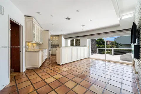 a view of a electric appliances and windows in a room