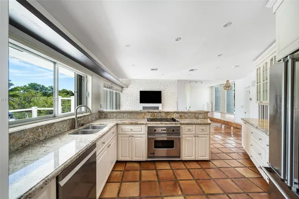 a kitchen with stainless steel appliances a stove sink and cabinets