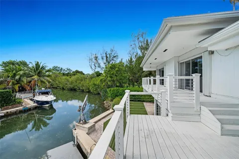 a view of a house with pool and sitting area