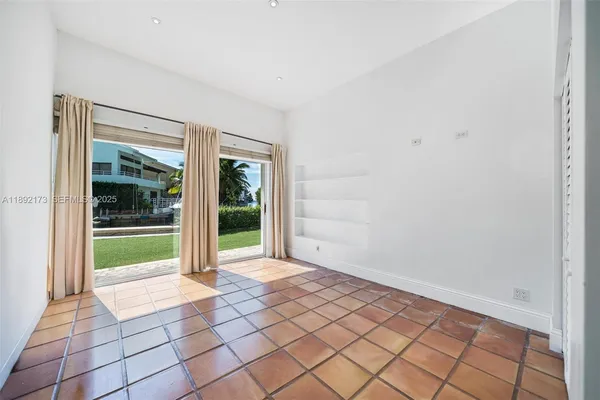 a view of an empty room with glass door