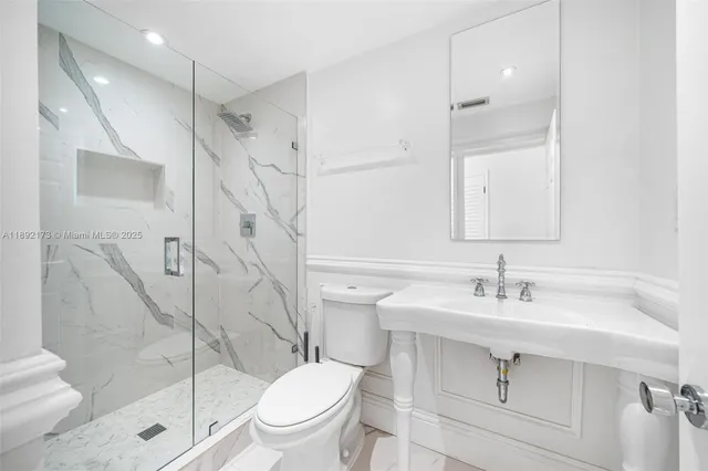 a bathroom with a sink toilet and shower