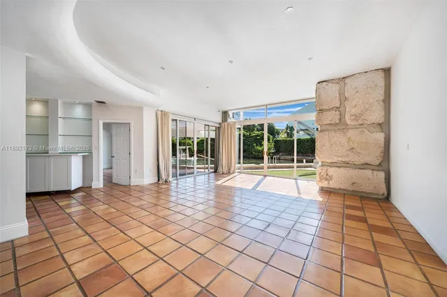 a view of a room with wooden floor and natural light