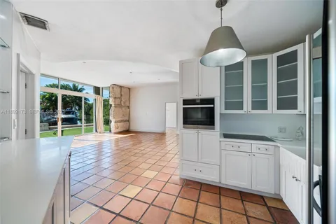 a view of a kitchen with windows and microwave