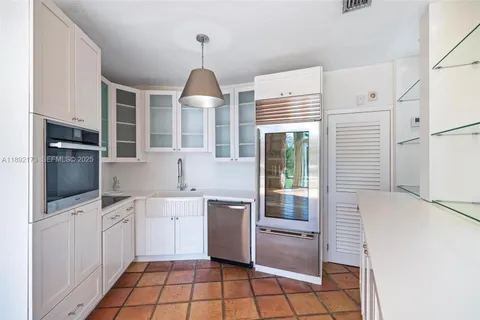 a kitchen with stainless steel appliances a refrigerator sink and microwave