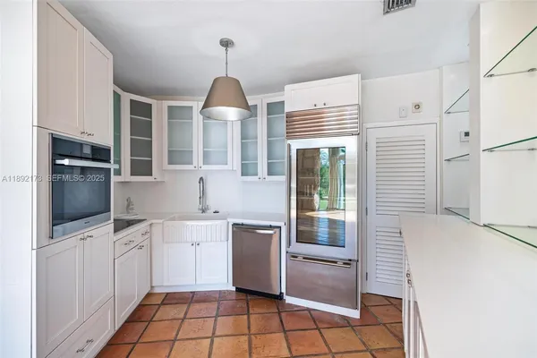 a kitchen with stainless steel appliances a refrigerator sink and microwave