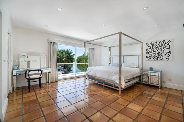 a bedroom with a bed and a view of balcony