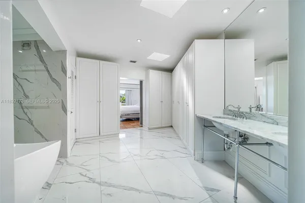 a bathroom with a sink a mirror and a shower