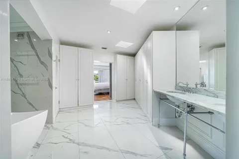 a bathroom with a sink a mirror and a shower